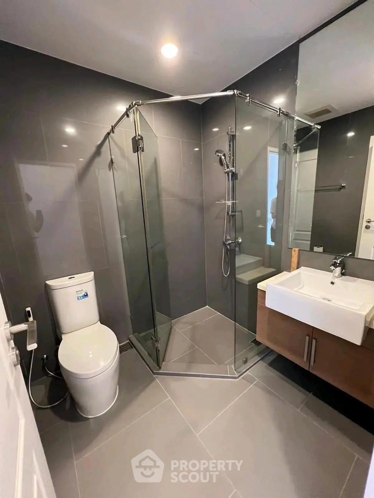 Modern bathroom with glass shower and sleek fixtures in a contemporary home.