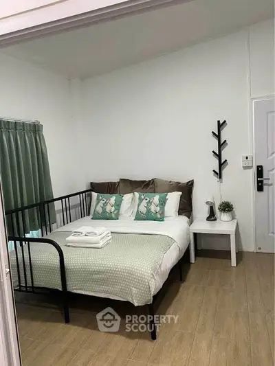 Cozy bedroom with modern decor and comfortable bedding in a stylish apartment.