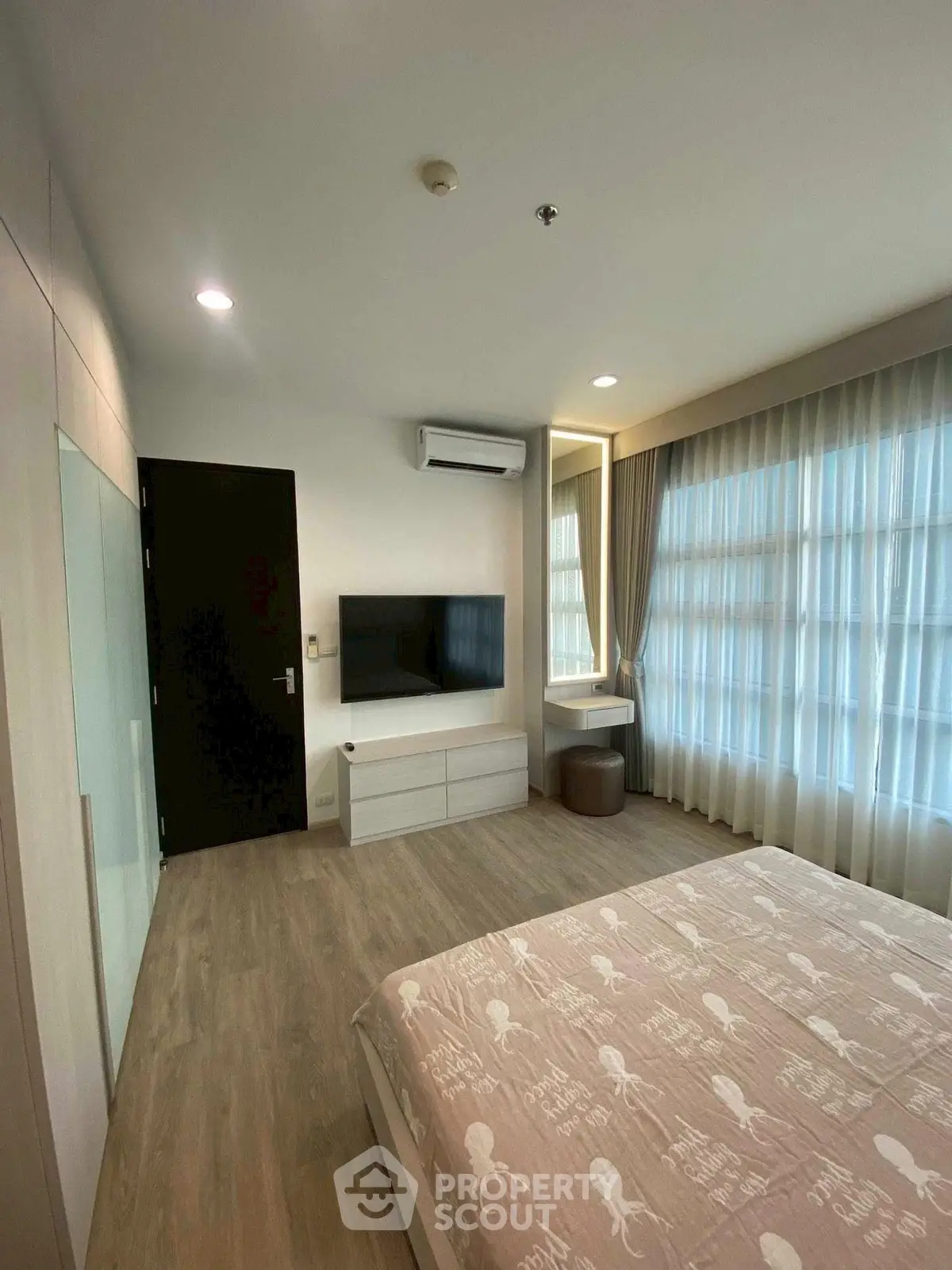 Modern bedroom with stylish decor and natural light