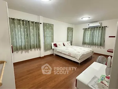 Spacious bedroom with elegant decor and wooden flooring
