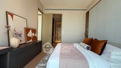 Luxurious bedroom with modern decor and stylish artwork, perfect for relaxation.