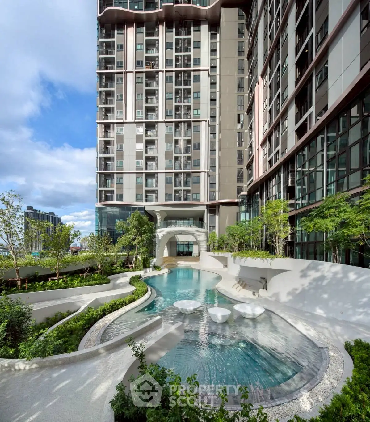Luxurious modern apartment building with stunning pool and landscaped garden area.
