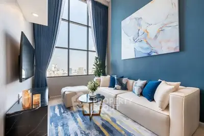 Luxurious modern living room with high ceilings and large windows offering city views.