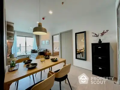 Modern open-plan living and dining area with stylish decor and balcony view.