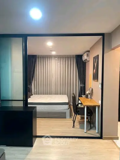 Modern bedroom with study area in stylish apartment featuring sleek design and natural light.