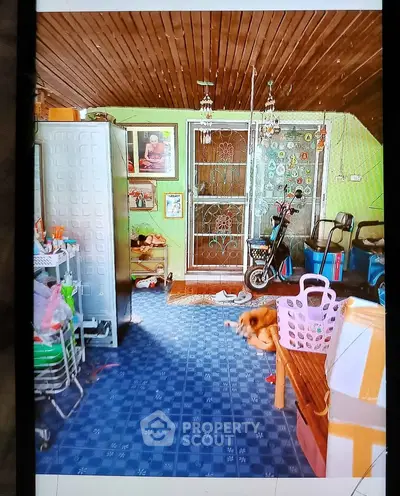 Charming interior space with unique decor and tiled flooring, featuring a cozy atmosphere and practical storage solutions.
