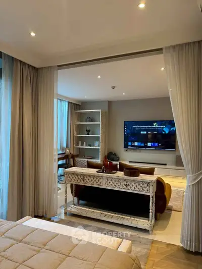 Luxurious living room with elegant decor and large TV, perfect for relaxation and entertainment.