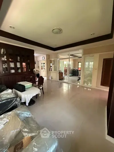 Spacious living room with elegant wooden cabinetry and large windows for natural light.