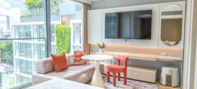 Modern living room with large window, stylish furniture, and city view in luxury apartment.