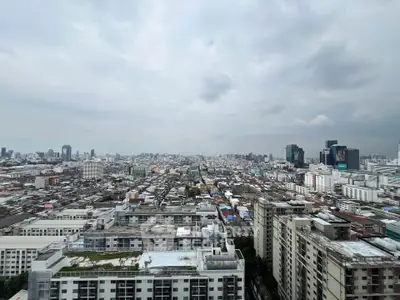 Stunning cityscape view from high-rise building showcasing urban skyline and architectural diversity.