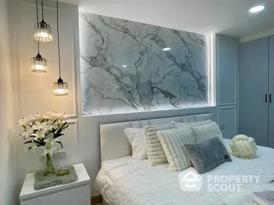 Luxurious modern bedroom with elegant marble accent wall and stylish lighting