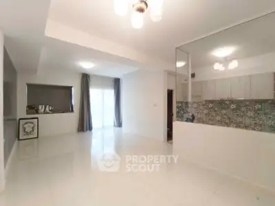 Spacious modern living room with open layout and large windows for natural light.