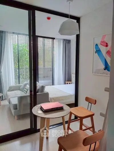 Modern apartment with cozy study area and view into stylish bedroom