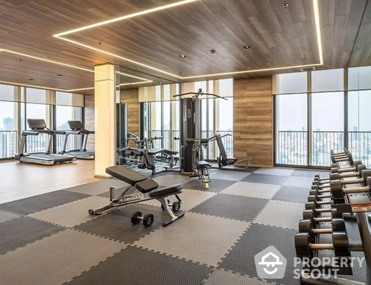 Modern gym with city view, featuring state-of-the-art equipment and stylish design.