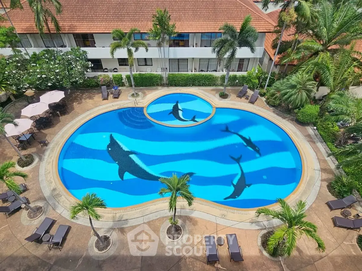 Stunning pool area with unique shark design, surrounded by lush greenery and modern amenities.