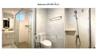 Pristine modern bathroom with glass shower enclosure, sleek fixtures, and well-lit vanity area, ideal for contemporary urban living.