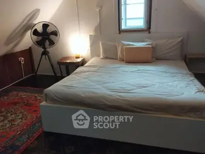 Cozy attic bedroom with stylish decor and natural light