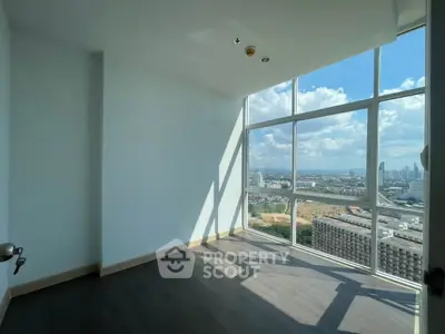 Bright corner unit with floor-to-ceiling windows offering stunning city views.
