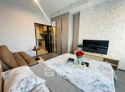 Modern bedroom with stylish decor and open kitchen view