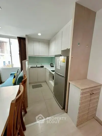 Modern kitchen with open layout and dining area in cozy apartment