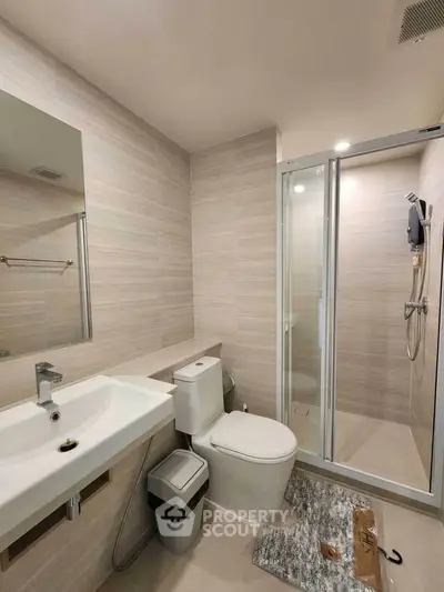 Modern bathroom with glass shower and sleek fixtures