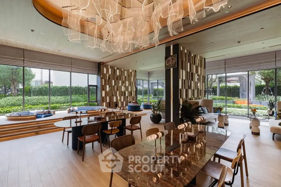 Luxurious modern living room with elegant dining area and floor-to-ceiling windows overlooking lush garden.