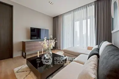 Modern living room with elegant decor, large TV, and floor-to-ceiling windows for natural light.
