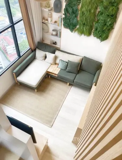 Modern living room with large window and stylish decor in a cozy apartment.