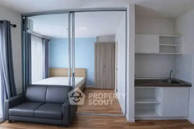 Modern studio apartment with sleek design and compact kitchen