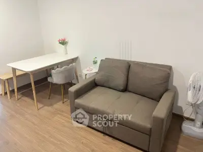 Cozy living room with modern sofa and dining table, perfect for small apartments.