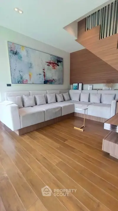 Spacious modern living room with stylish decor and wooden flooring