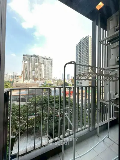 Urban balcony with city view and drying rack, perfect for modern living.