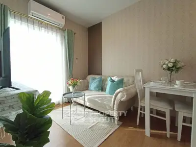 Charming living room with elegant sofa and dining area, perfect for cozy gatherings.