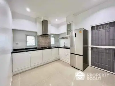 Modern kitchen with sleek white cabinetry and stainless steel appliances