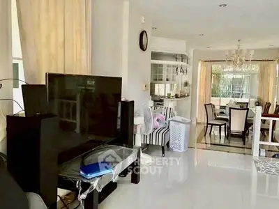 Spacious living room with modern decor and dining area, perfect for family gatherings.