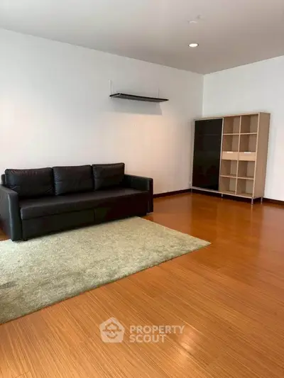 Spacious living room with wooden flooring and modern furniture