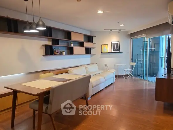 Spacious living room with modern decor and large balcony access.