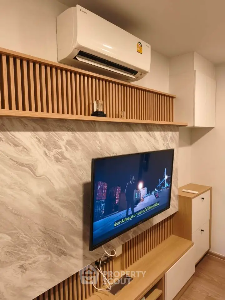 Modern living room with wall-mounted TV and air conditioning unit