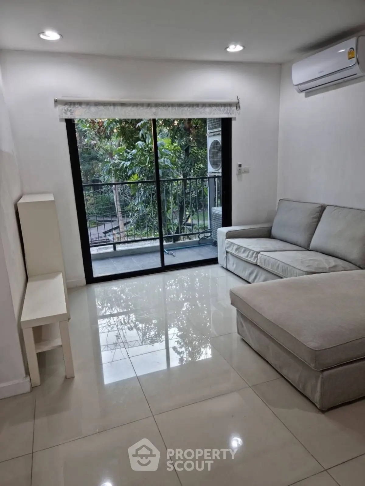 Modern living room with sleek sofa and balcony view