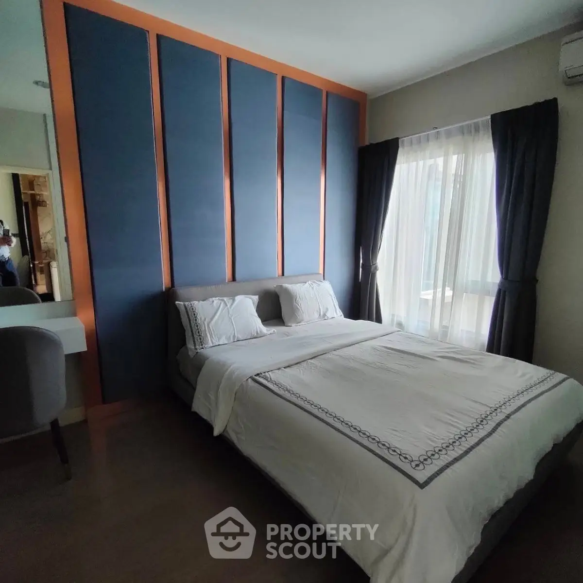 Modern bedroom with stylish accent wall and cozy bedding