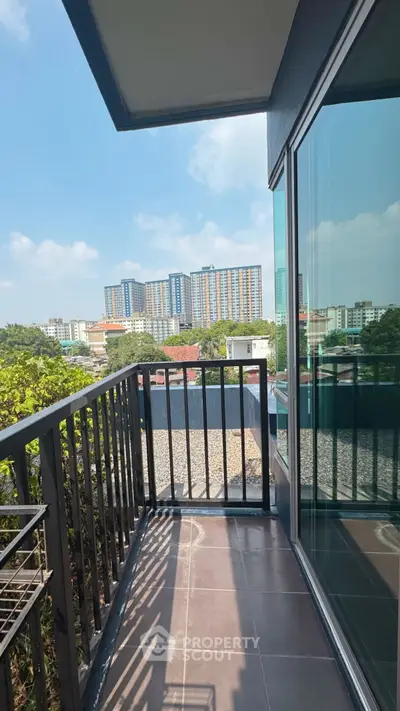 Charming balcony with city view, perfect for relaxing and enjoying the skyline.