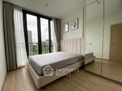 Modern bedroom with large windows and stylish decor in a high-rise apartment.
