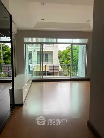 Spacious living room with large windows offering a bright and airy atmosphere, perfect for modern living.