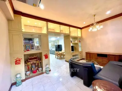 Spacious living room with elegant built-in shelves and cozy seating area