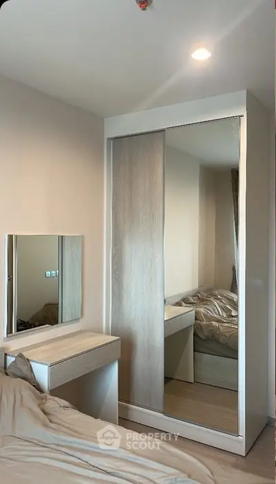 Modern bedroom with sleek wardrobe and cozy bed setup