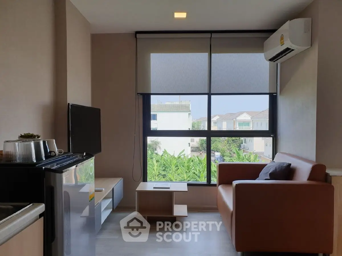 Modern living room with large window and stylish furniture