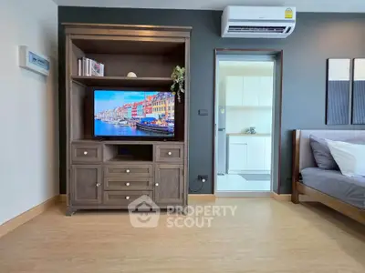 Modern living room with stylish wooden TV cabinet and sleek air conditioning unit.