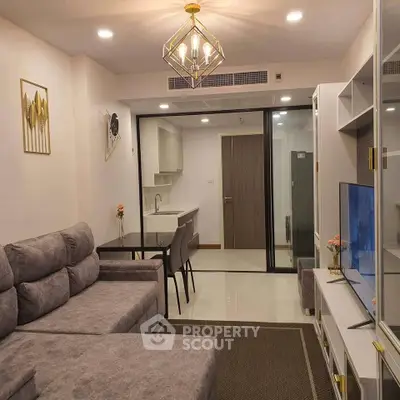 Modern living room with stylish decor and open kitchen layout in a contemporary apartment.