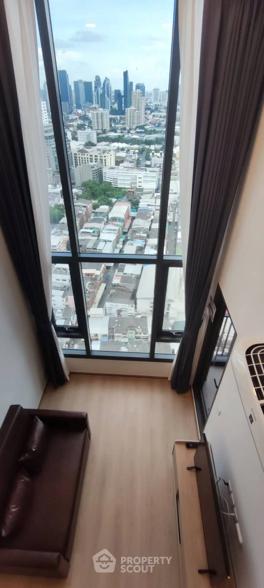 Stunning high-rise apartment with floor-to-ceiling windows offering breathtaking city views.