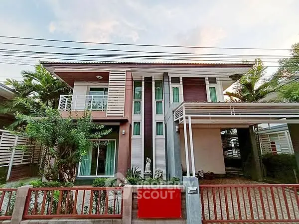 Modern two-story house with stylish facade and lush greenery